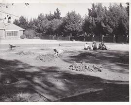 1960 School grounds with workmen